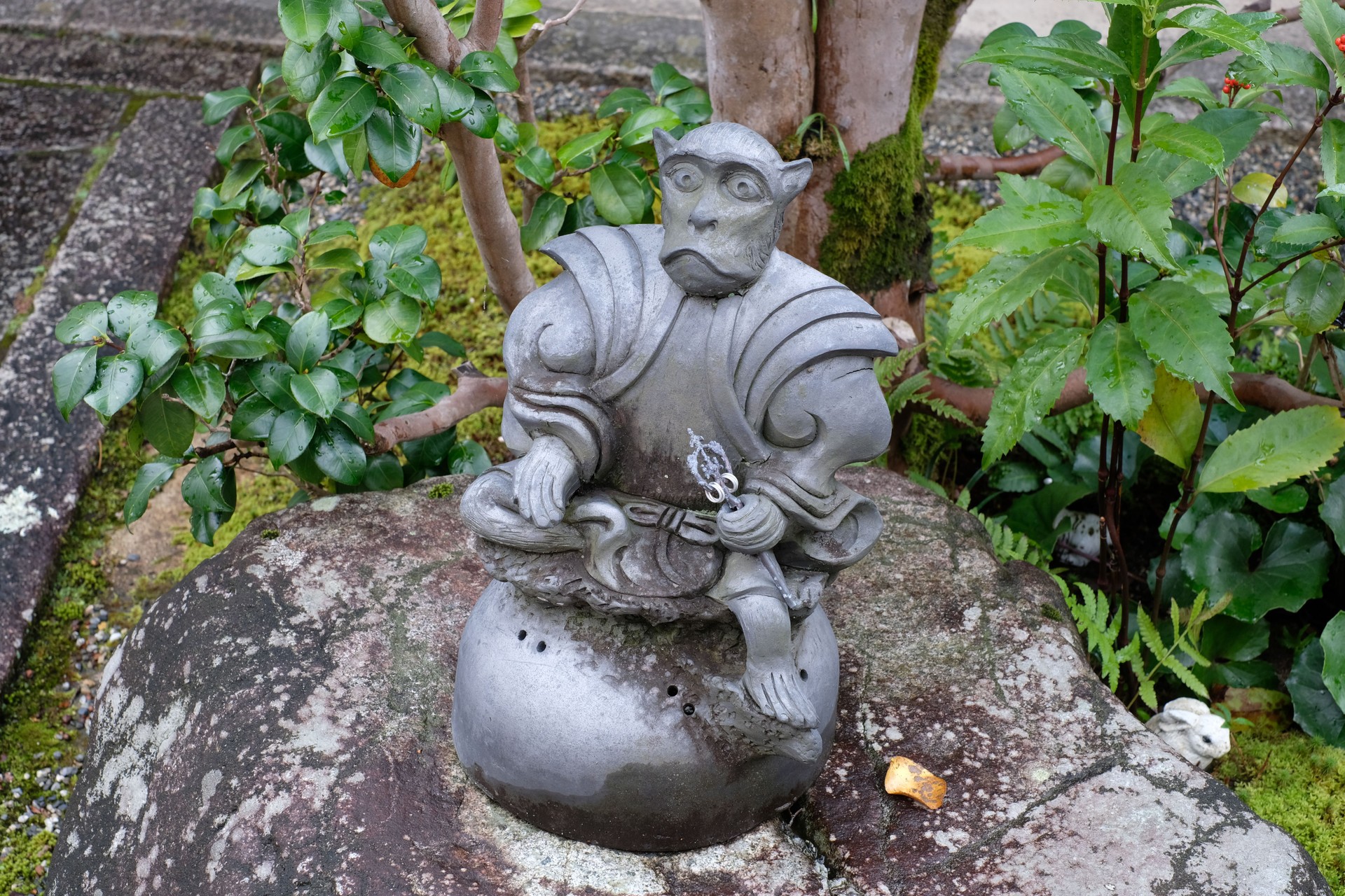 Statue of a monk monkey in the garden of Saikyo-ji Buddhist temple in Shiga, Japan