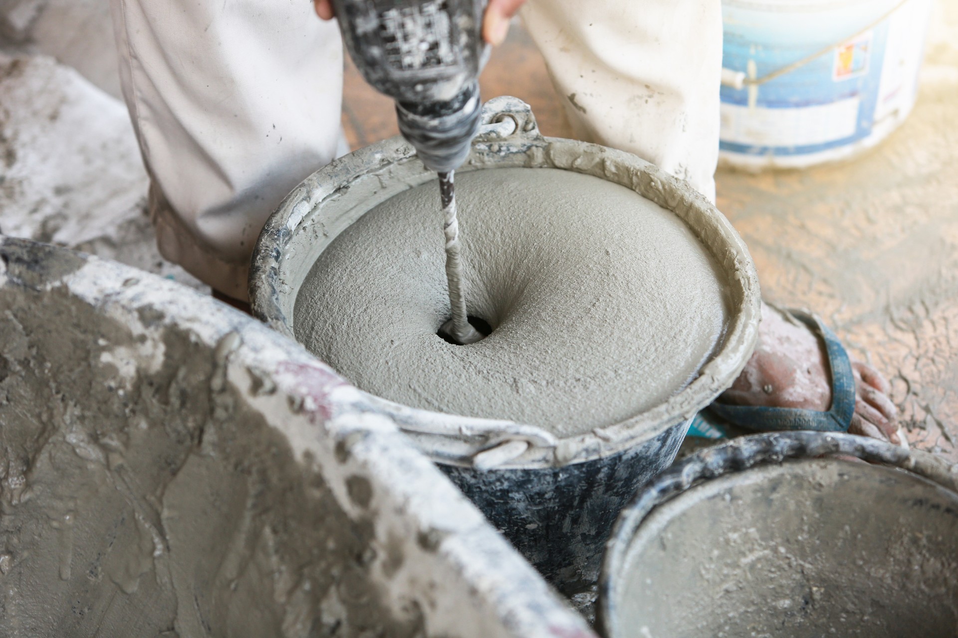 Cement or mortar is inside cement mixer in bucket.