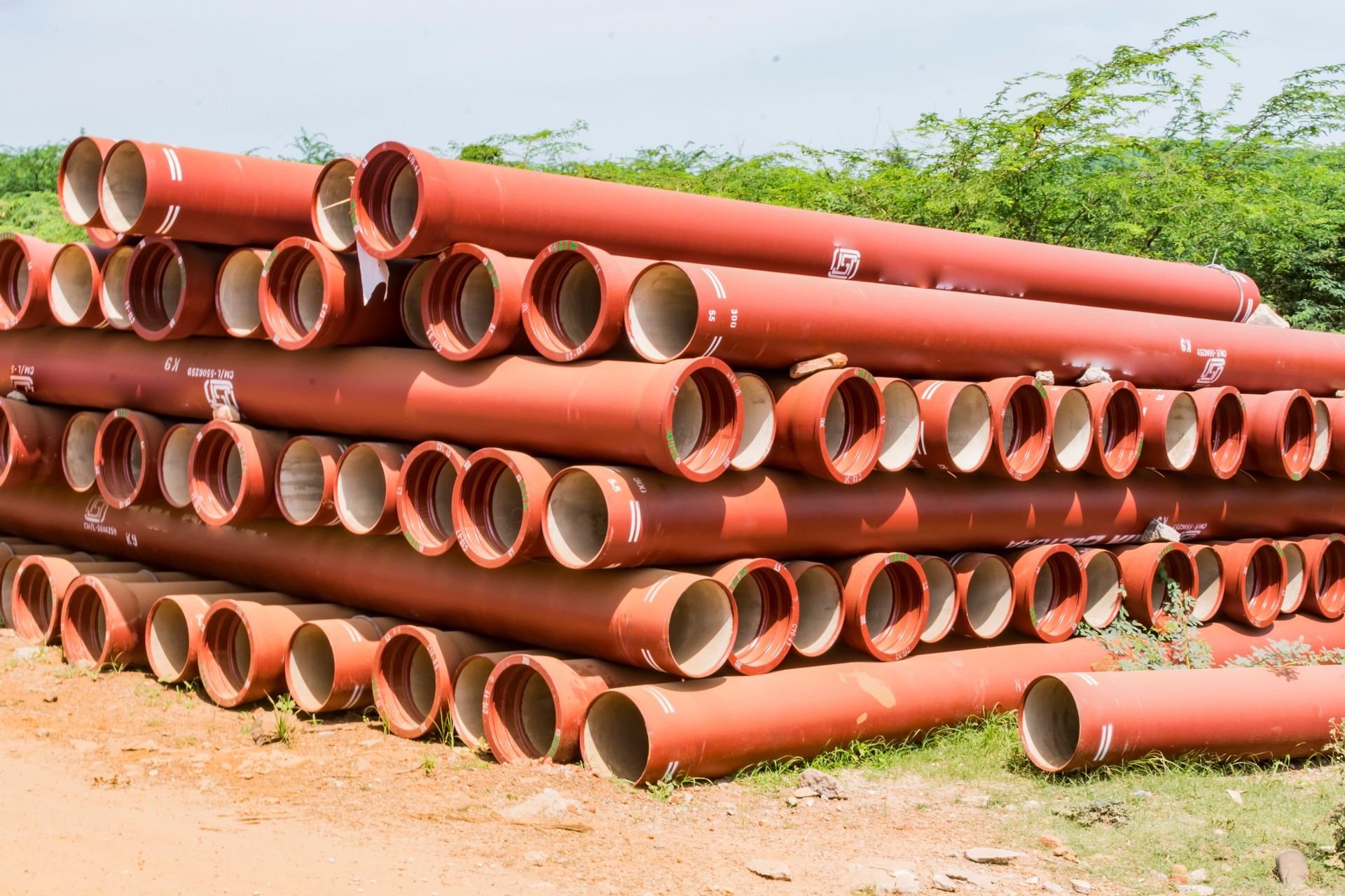 ductile iron pipes stocked in open space of a rural village store yard.